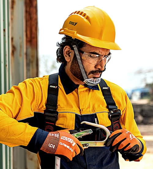 Technician wearing Udyogi safety gear in a professional setting